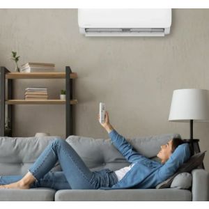 Woman lying on the couch with a remote of mini split