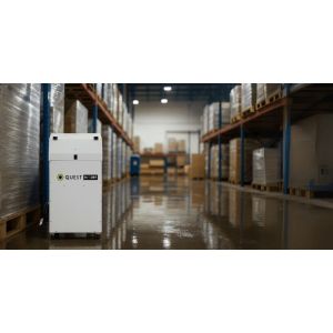 Quest Hi-DRY commercial dehumidifier operating in a warehouse aisle with pallet racks and a wet, reflective floor