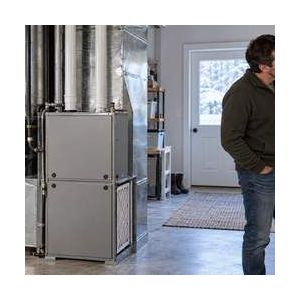 Residential gas furnace and thermostat in a utility room