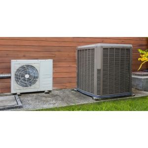 Goodman heat pump condenser and air conditioner side by side outside a home.