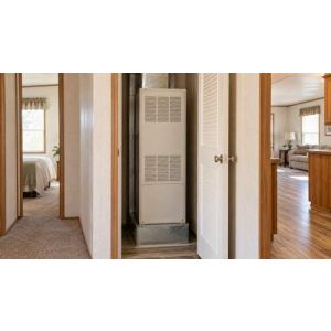 Compact furnace cabinet inside a manufactured-home utility closet