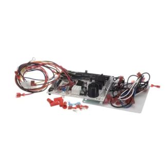 Reznor replacement kit laid out on a white surface. Included are a circuit board, two wire harnesses, a metal mounting plate, hardware connectors, zip ties, and printed instruction sheets.