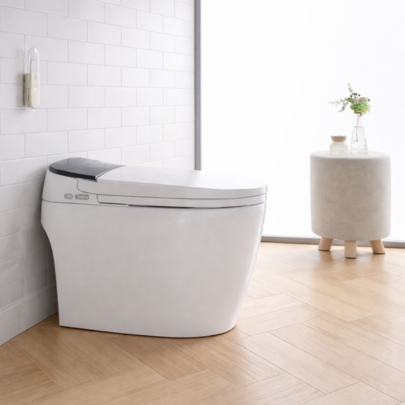 ACiQ smart toilet installed in a modern bathroom with white tile walls and light wood flooring