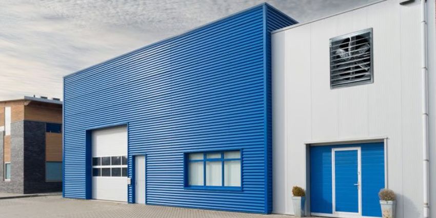 ACiQ cabinet wall-mounted exhaust fan installed on a commercial building exterior for industrial ventilation and airflow control