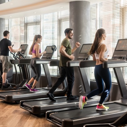 People running on treadmill in gym with dehumidifier