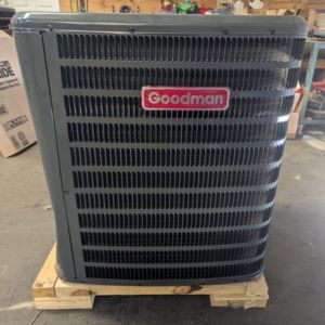 Goodman heat pump condenser outdoor unit sitting on pallet ready for installation