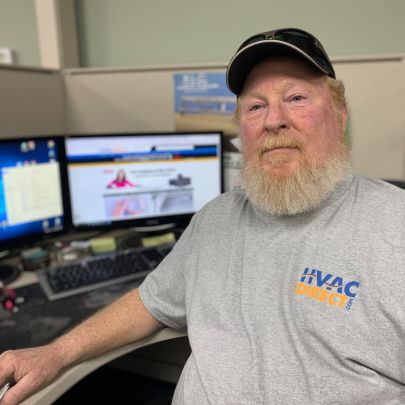 HVACDirect.com customer support team member assisting customers at office workstation