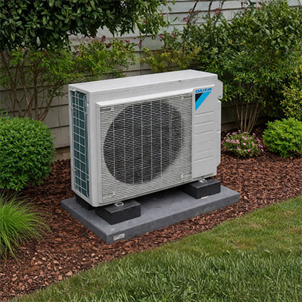Daikin mini split outdoor condenser installed outside home showing ductless HVAC system