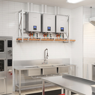 Noritz NCC commercial tankless water heaters installed above a stainless steel sink in a commercial kitchen