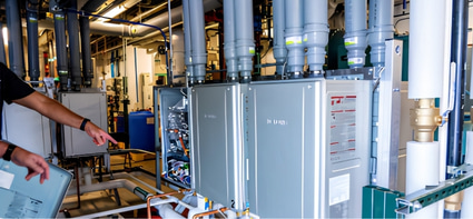 Multiple Noritz commercial tankless water heaters installed together in a mechanical room to provide scalable hot water capacity and redundancy.